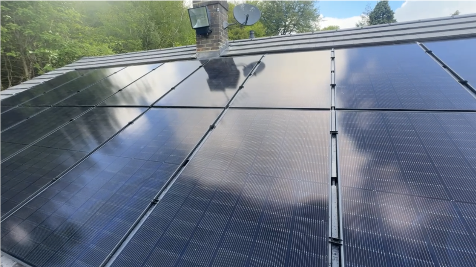 All-black panel array on tiled roof with chimney flashing detail. — solar PV installation in Tadworth by Solid Electrical