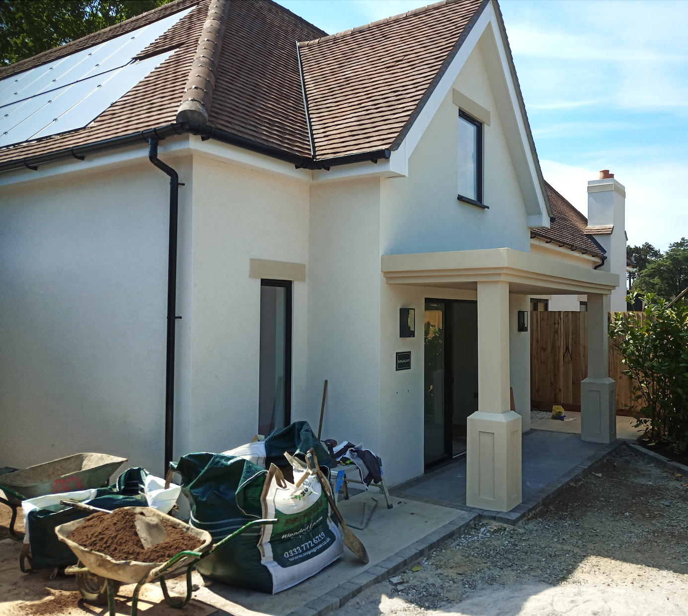New build home in London with integrated black solar PV panels on a tiled pitched roof